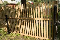 New Picket Fence And Black Metal Poles Built In The Garden Stock with regard to sizing 1300 X 853