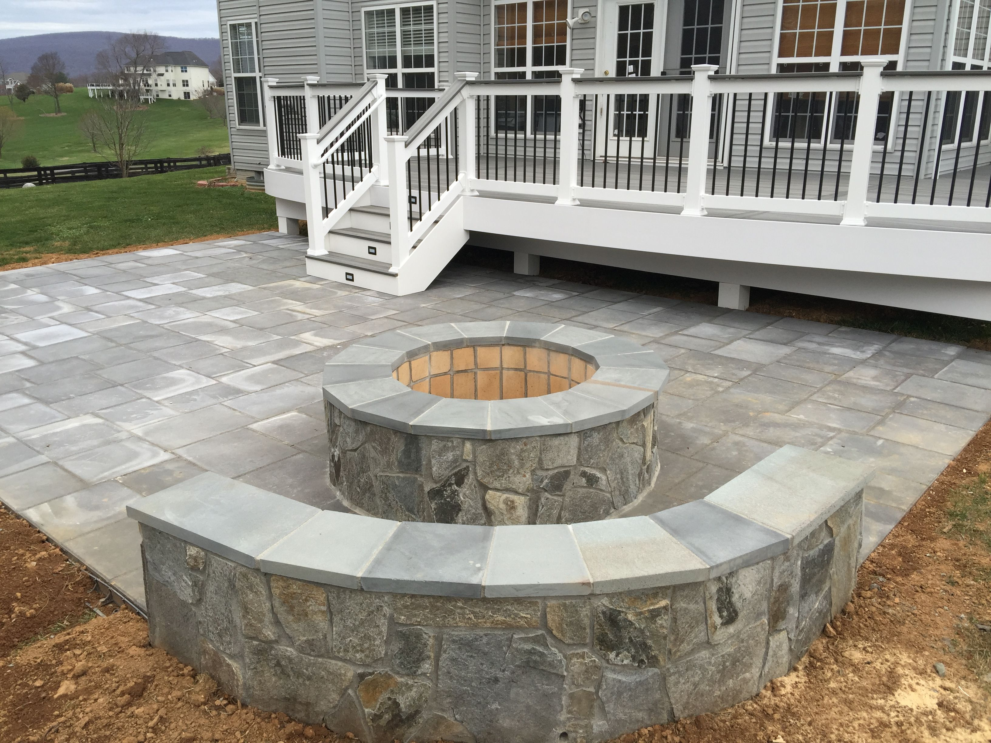 A Beautiful Paver Patio With Stone Seating Walls And A Fire in dimensions 3264 X 2448