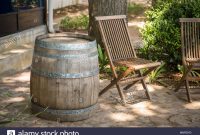 An Empty Wooden Patio Chair Positioned Next To Barrel On regarding proportions 1300 X 956