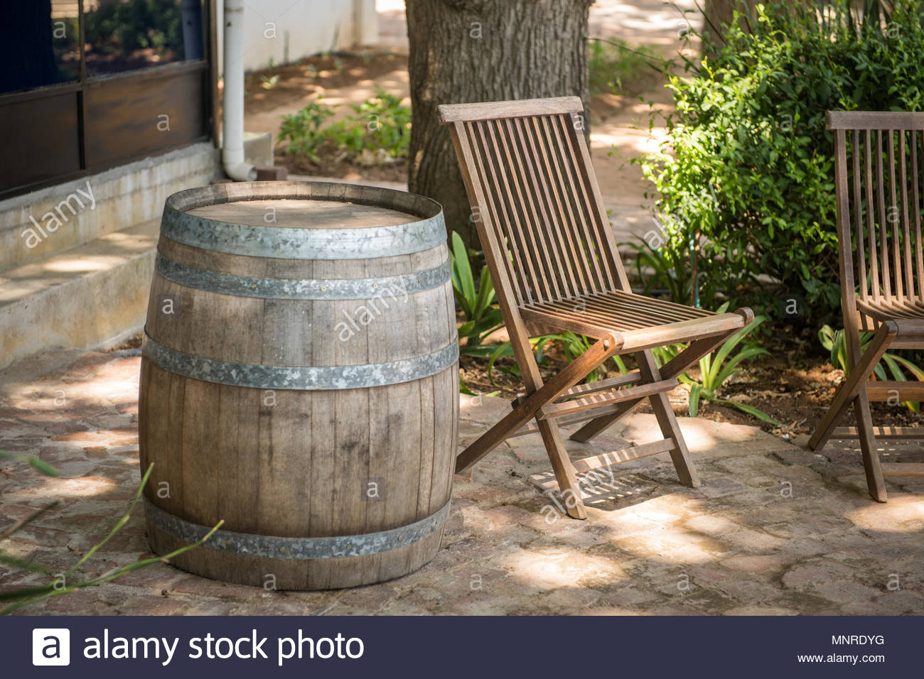 An Empty Wooden Patio Chair Positioned Next To Barrel On throughout size 1300 X 956