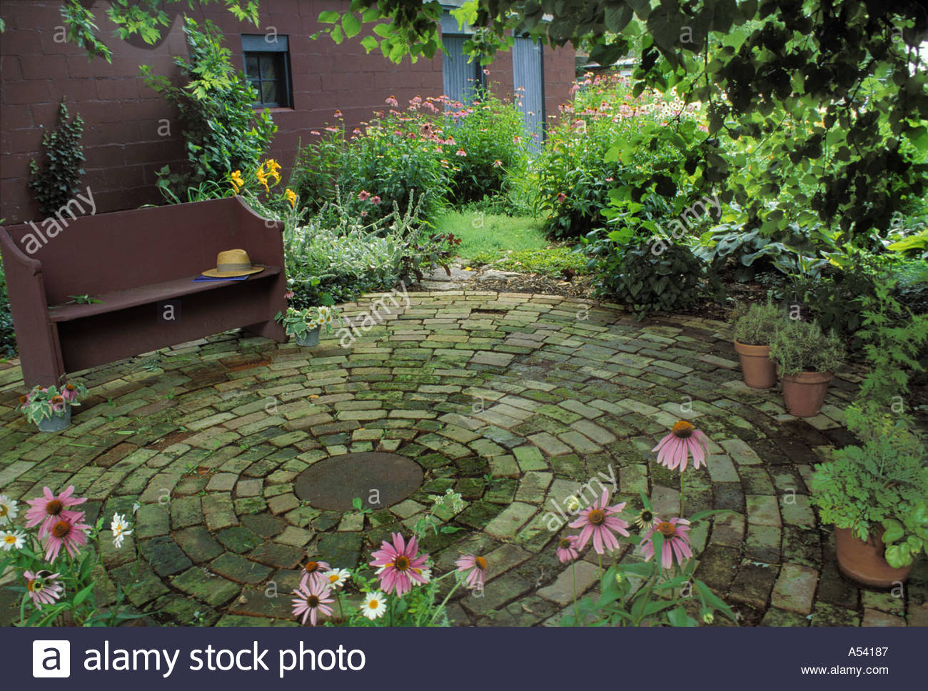 Antique Brick Circular Patio With Antique Bench Under Tree for measurements 1300 X 968