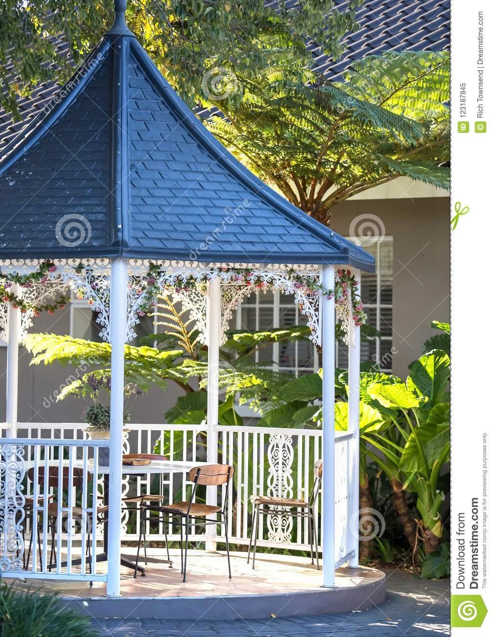 Garden Feature With Tables And Chairs Editorial Image intended for measurements 1009 X 1300