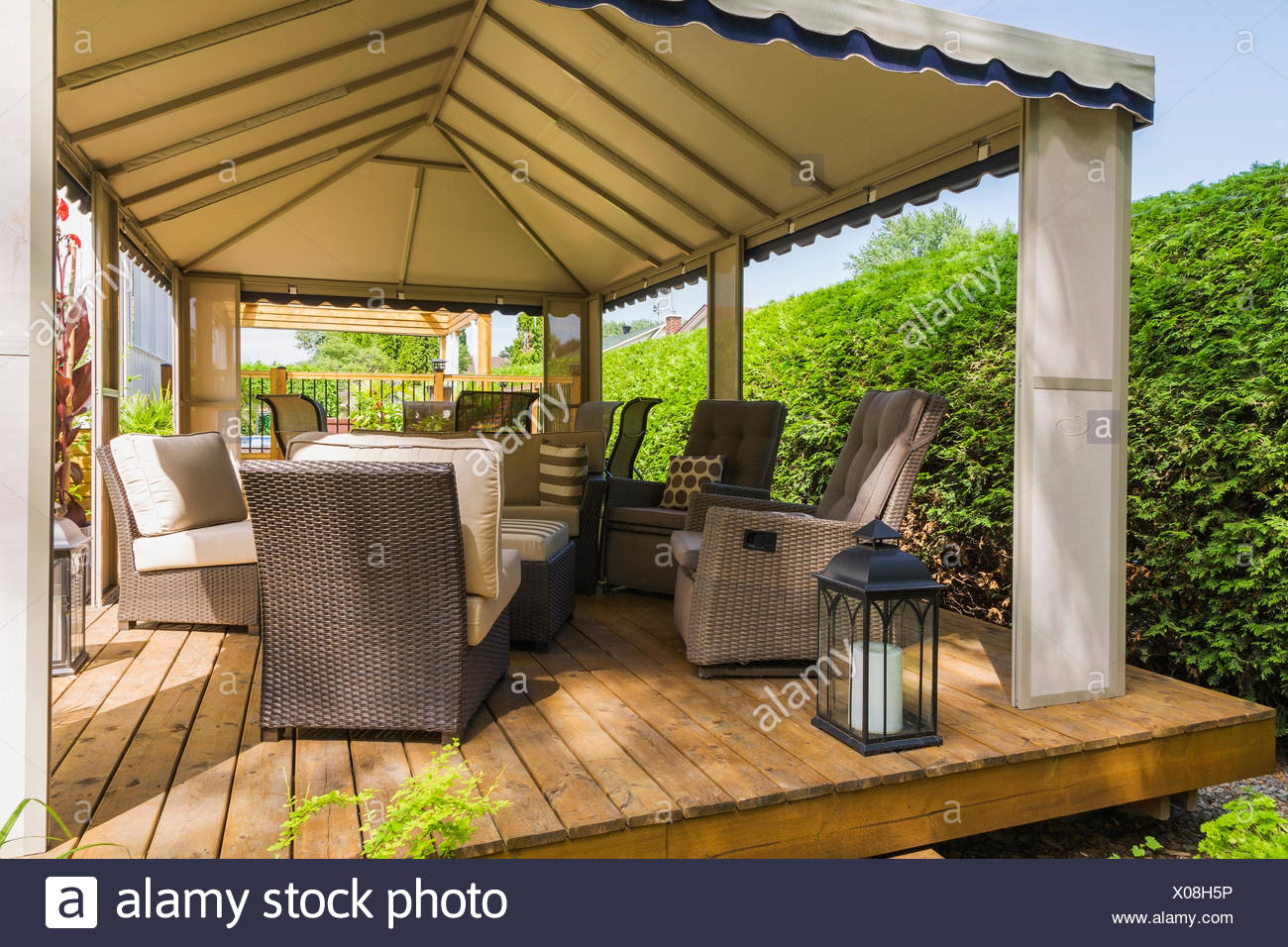Gazebo On Wooden Deck Furnished With Wicker Furniture in sizing 1300 X 956