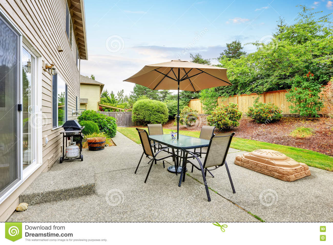 Patio Table Set With Umbrella In The Back Yard Stock Image intended for sizing 1300 X 957