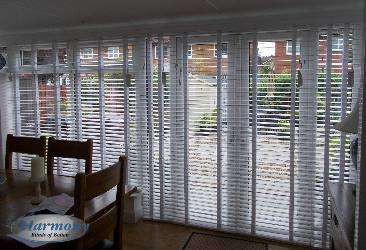 White Wooden Blinds With Tapes Covering Patio Doors within size 1170 X 800