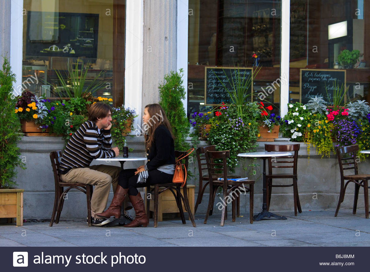 Young Couple Sits At Table Outside Bistro Old Town Montreal pertaining to dimensions 1300 X 956